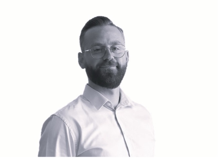 Portrait of Daan Verbesselt wearing glasses and a shirt, smiling slightly against a white background.