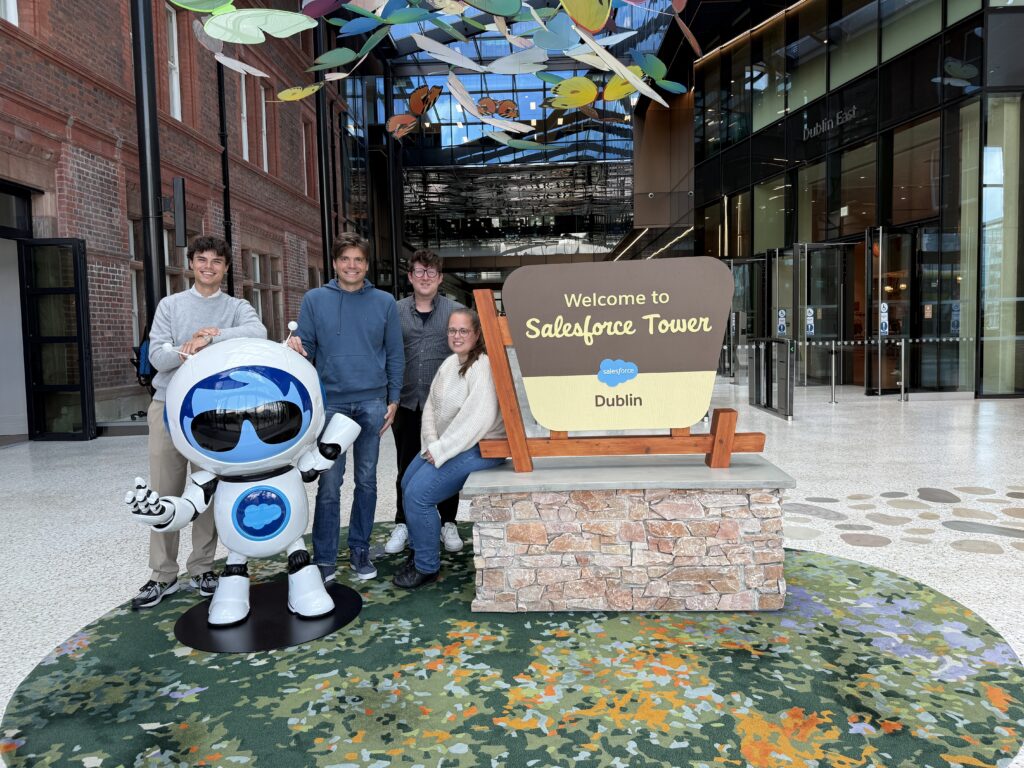 Spire team posing with Salesforce Agentforce mascot at Salesforce Tower Dublin lobby